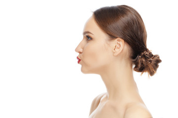 Lovely girl looking away, standing in profile and giving a virtual kiss