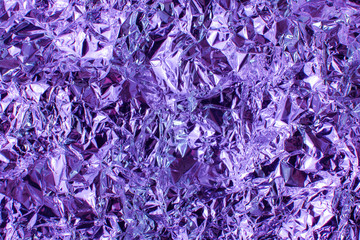 Holographic iridescent metallic foil. Real Hologram Background of wrinkled abstract foil 80s...