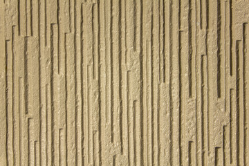 Fototapeta premium gray yellow white beige rough surface with deep relief and shadows, vertical lines