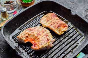 Grilled chicken breast in a pan.