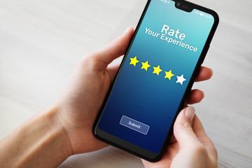 Rate your experience customer satisfaction review Five Stars on mobile phone screen. Business...