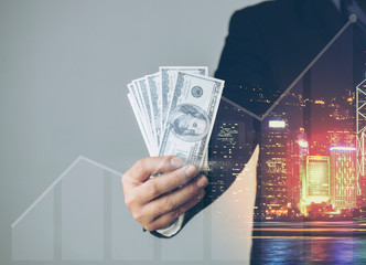 Double exposure of Businessman with money in hand, US dollar (USD) bills - investment, success and profitable business concepts