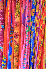 Colorful sarong scarves hanging on display in a market