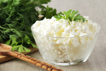 A bowl with cottage cheese and a bunch of green	