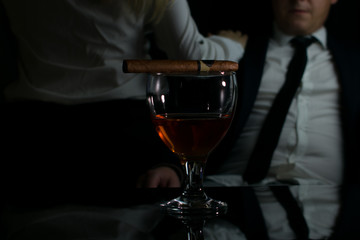 businessman resting in a bar in a society of women