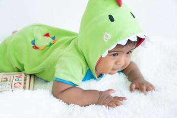 cute little asian baby boy lying and play toy