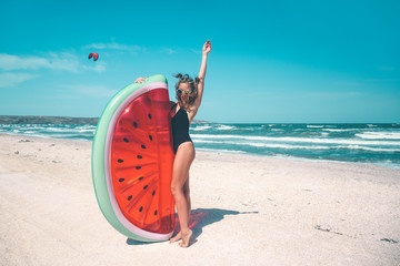 Naklejka na ściany i meble Model with watermelon lilo at the beach