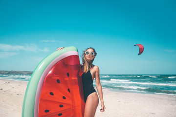 Naklejka na ściany i meble Model with watermelon lilo at the beach