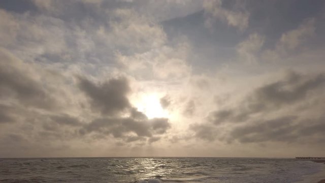 Amazing golden hour sunset at sea with dramatic sky and beautiful light between cirrus clouds and cavum cloud