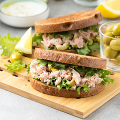 Sandwich with tuna, olives and lemon. Delicious lunch, healthy food, snack with fish on crispy toast
