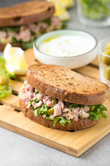 Sandwich with tuna, olives and lemon. Delicious lunch, healthy food, snack with fish on crispy toast