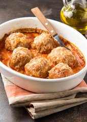 Meatballs in tomato sauce with cheese, baked meat cutlets from pork and beef in a baking dish. Delicious home cooked food