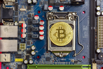 Top view of golden bit coin on computer mother board