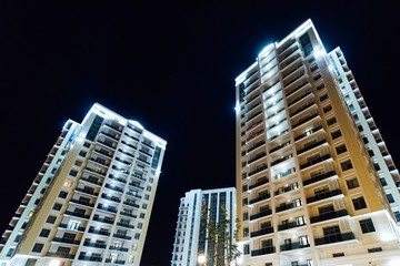 Fototapeta premium New multi-storey building under construction at night