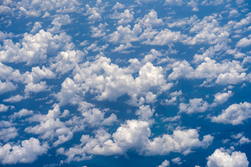 White clouds and blue sky, a view from airplane window