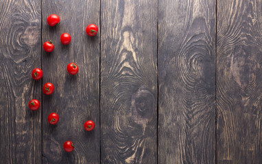 Top view. Small cherry tomato on dark boards