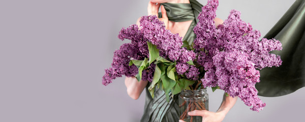 Elegant woman with a huge bouquet of purple lilac - Powered by Adobe