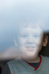 boy behind glass, home seeing
