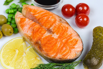 Grilled piece of arctic char among canned vegetables and seasoning
