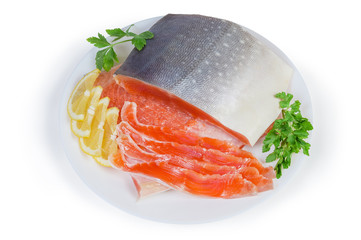 Partly sliced salted arctic char on dish on white background