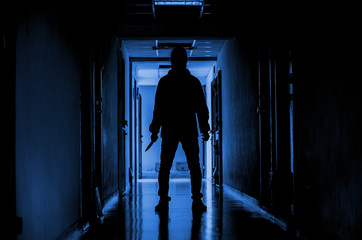 murder, kill and people concept - Criminal or murderer wearing a mask in silhouette holding knife...