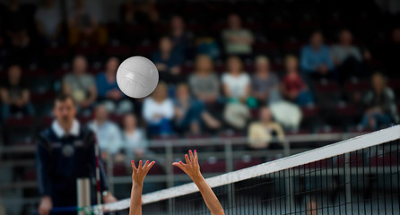 Girl Volleyball player and setter setting the ball for a spiker during a game