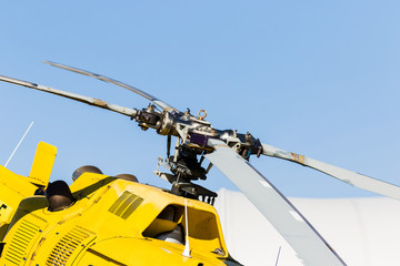 detail of the rotor of a yellow helicopter with the sky in the background © ihorga