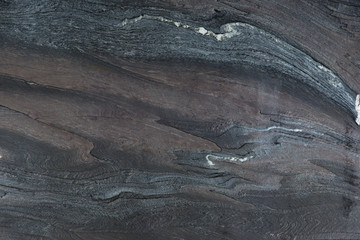 Natural dark stone with beautiful red patterns, called quartzite Rosso Luana