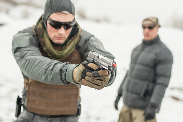 Army soldier training combat gun winter snow shooting with instructor