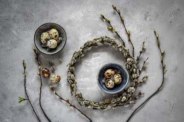 Quail eggs and pussy willow wreath as a symbols of spring and Easter, dark mood