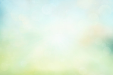 Spring or summer background. Green and yellow blurred abstract background with magic lights