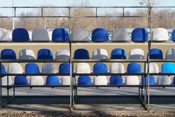 Back view of the grandstand. Amphitheater of white and blue seats. Moscow stadium at spring sunny...