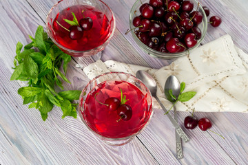 Jelly from a sweet cherry on a wooden background