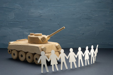 Raw of paper people rallying in front of a tank. Protest, demonstration toy concept. Activism, social movement.