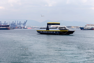 Fototapeta premium A swimming ferryboat on a overcast day