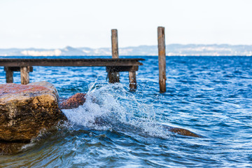 Fototapeta premium Splash of wave on Garda lake, Italy