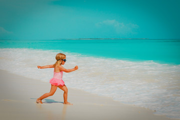 Fototapeta premium słodka mała dziewczynka idzie popływać na plaży
