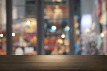 Empty dark wooden table in front of abstract blurred bokeh background of restaurant . can be used for display or montage your products.Mock up for space.