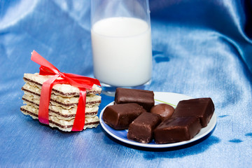 bottle of milk with blue background and biscuit