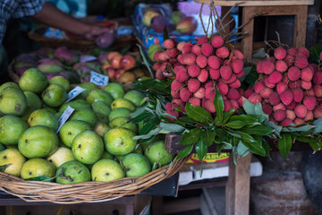 Fresh limes and lychees at tropical market