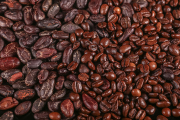 Roasted beans. Cocoa beans and coffee beans isolated on black background.