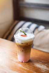 strawberry iced latte on wooden table