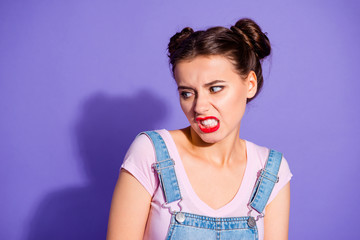 Close up photo beautiful amazing she her lady two hair buns ugh facial expression look disgusted side empty space wear casual t-shirt jeans denim overalls clothes isolated purple violet background