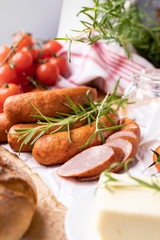 Smoked sausage, thin sausage in composition with vegetables and herbs