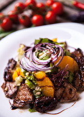 Salad with veal and orange slices and fresh herbs