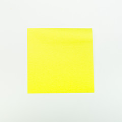 Yellow paper stick note on a white background