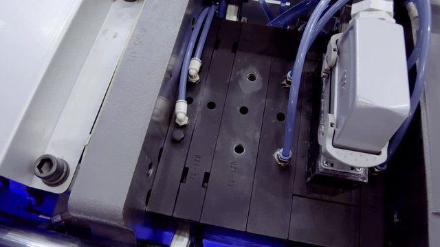 Automatic plastic injection molding machine.