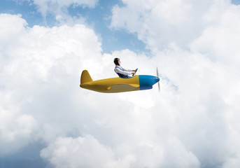 Naklejka premium Happy pilot driving small propeller plane