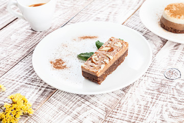 Close up view on vegan raw brownie cake on white wooden background with espresso cup. vegetarian dessert for breakfast. Healthy food with copy space for design and text.