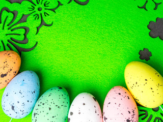 easter color eggs on green background, free space for text